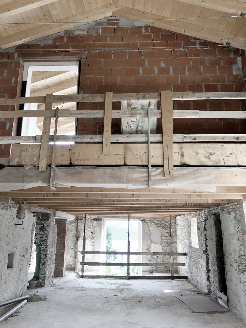 Rohbau im Inneren mit Holzbalken und geöffneten Wänden