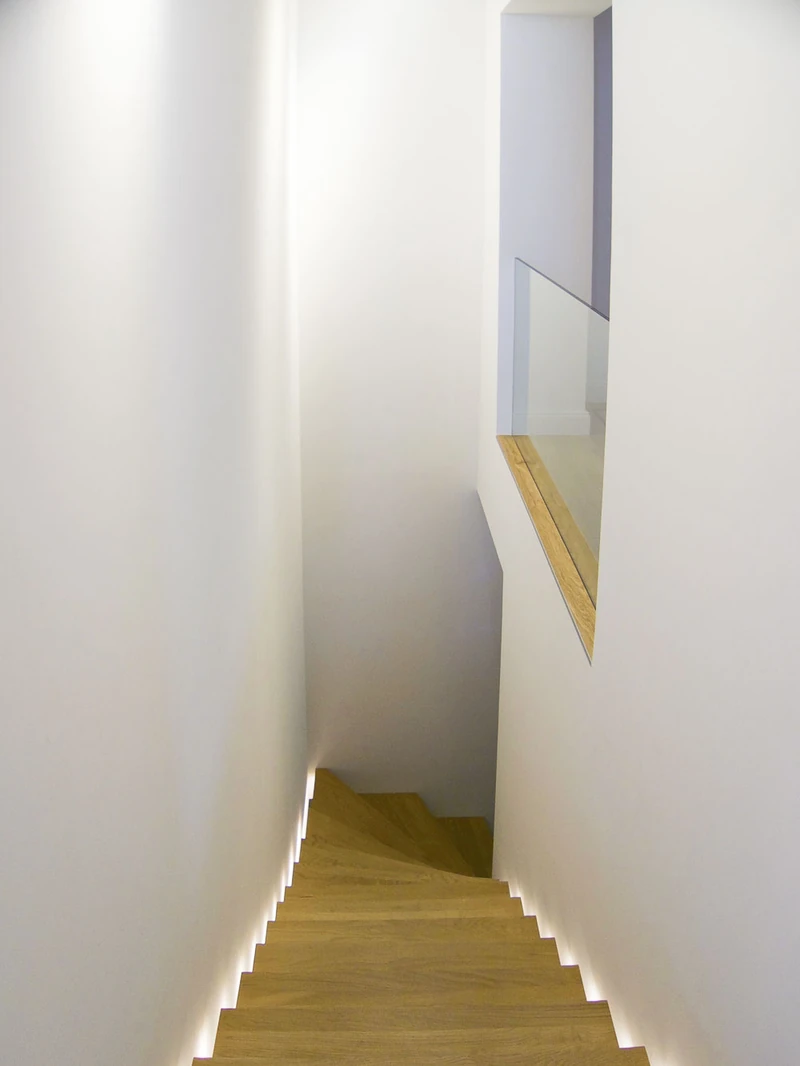 Blick von oben auf die Holztreppe mit Lichtband