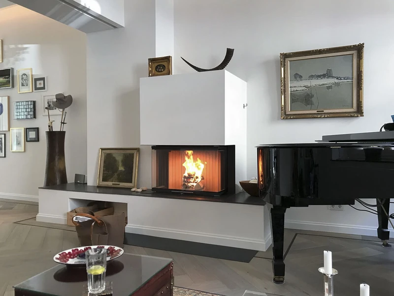 Wohnraum mit Kamin, Flügel und Bildern an der Wand